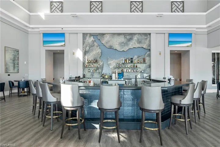 Azure Bar featuring wood-type flooring and a high ceiling