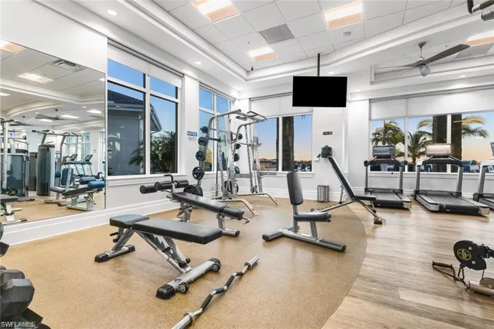 Gym featuring ceiling fan and a drop ceiling