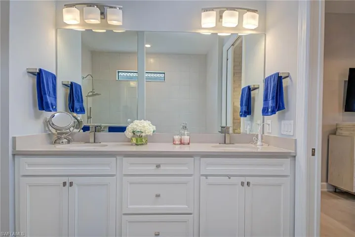 Bathroom with a tile shower and vanity