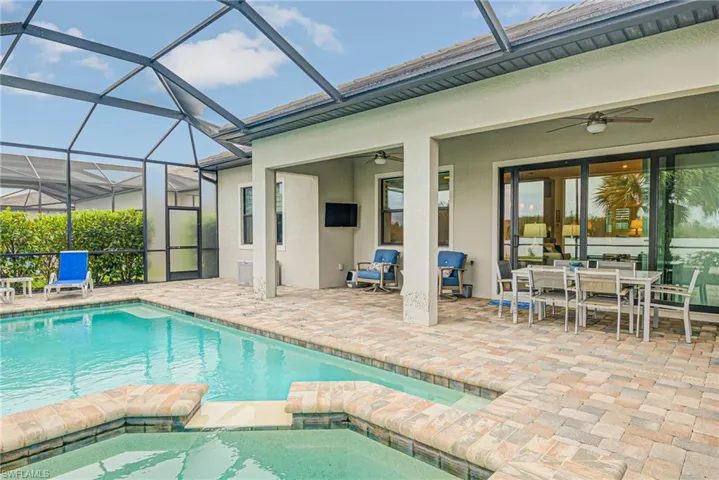 View of pool with an in ground hot tub, a patio area, and ceiling fan