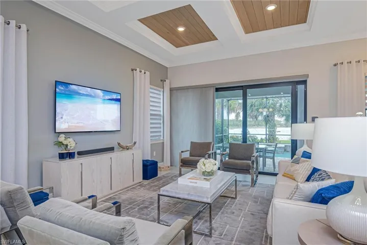 Living room featuring wood ceiling, coffered ceiling, and ornamental molding
