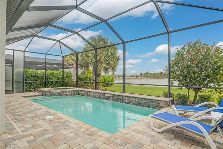 View of pool featuring a lanai, an in ground hot tub, and a patio