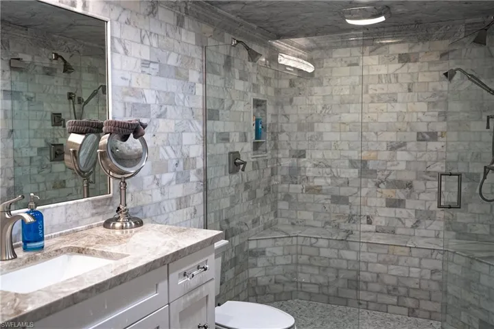 Bathroom with a shower stall and vanity