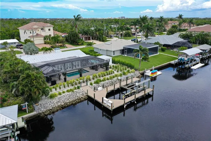 Aerial perspective of suburban area featuring a large body of water
