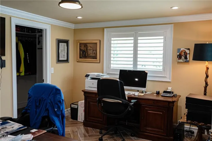 Office space with parquet floors, crown molding, and recessed lighting