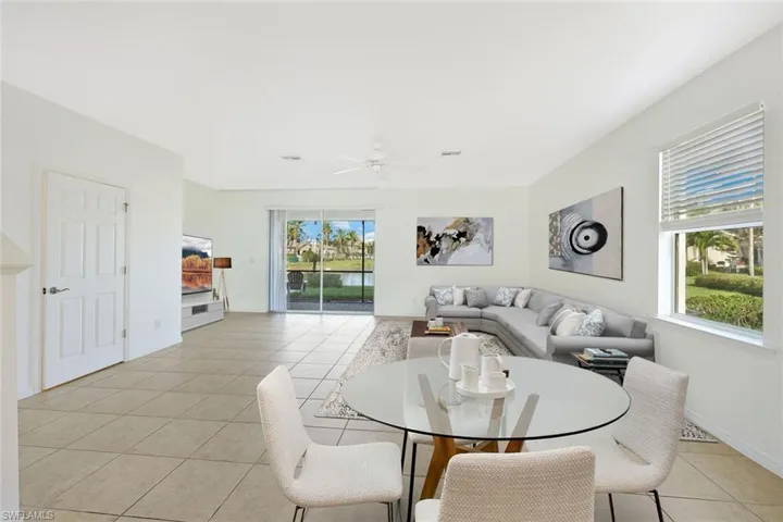 Dining area with light tile patterned floors and ceiling fan