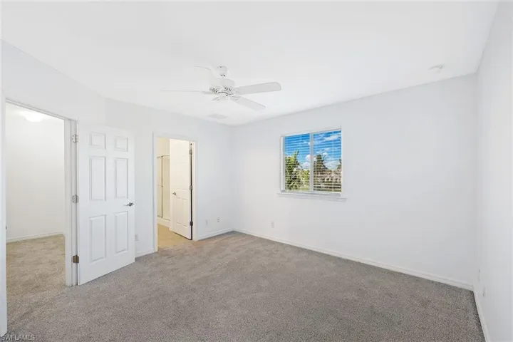 Unfurnished bedroom with carpet floors and a ceiling fan