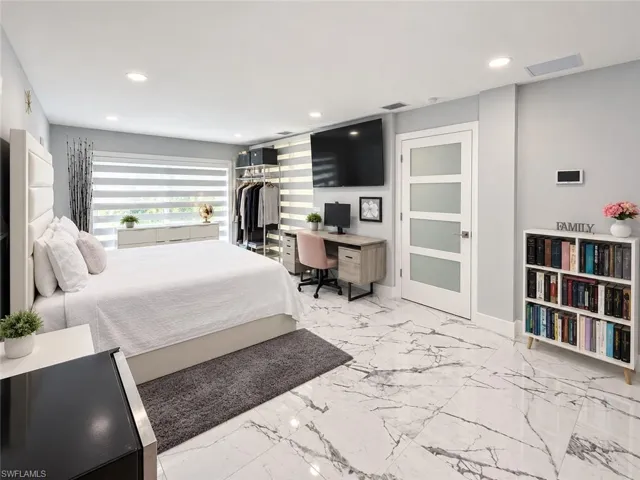 Recessed lighting illuminates marble-look flooring