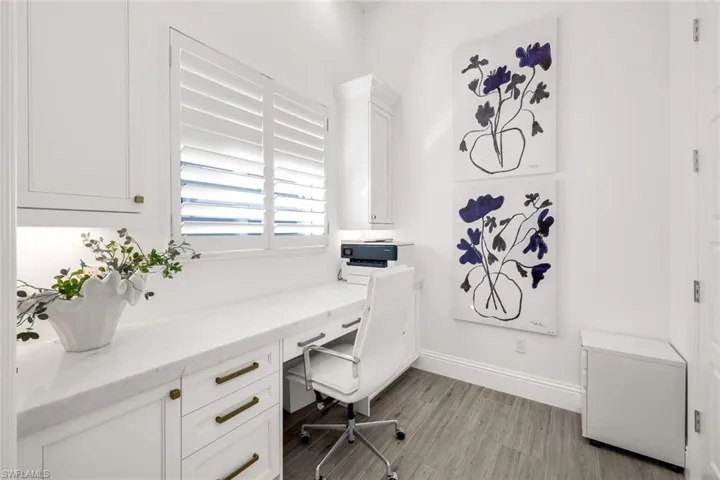 Pocket Doors off the kitchen leading to Wonderful Office area with Built-in desk, plantation shutters, and French Doors leading to custom closet with great storage!