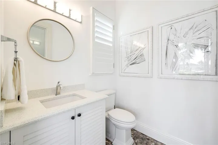 Beautiful pool powder bath with plantation Shutter detail over window!