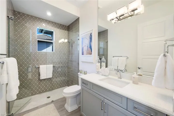Guest bathroom #3 with stunning tile detail and lovely natural light through window!