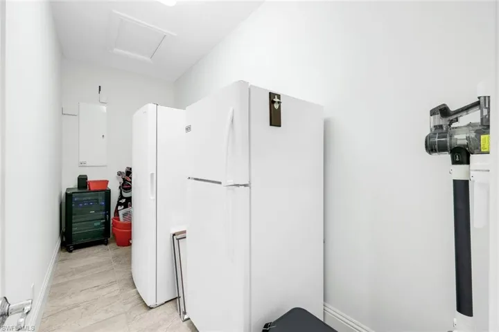 Hallway storage area with 1 refrigerators and a deep freezer!
