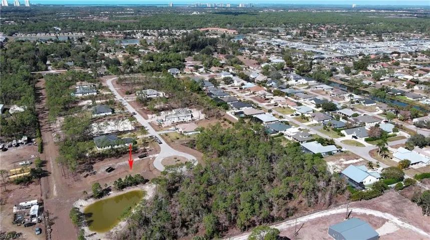 Aerial view of property's location featuring a large body of water and nearby suburban area
