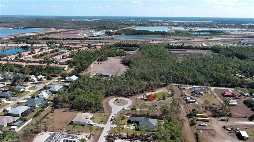 Aerial view of property and surrounding area featuring a nearby body of water