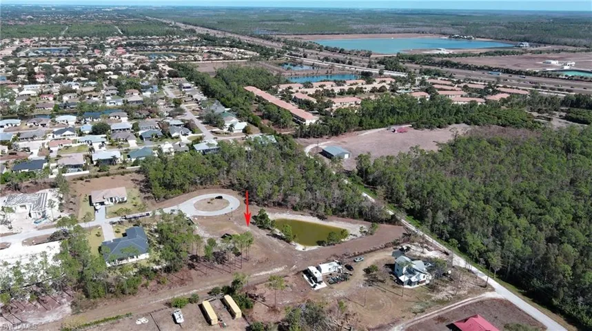 Aerial view of property and surrounding area with a nearby body of water