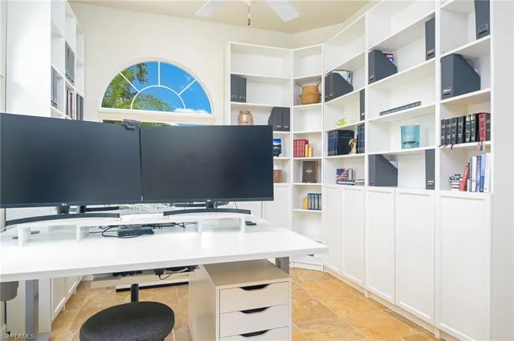 Tiled home office featuring ceiling fan