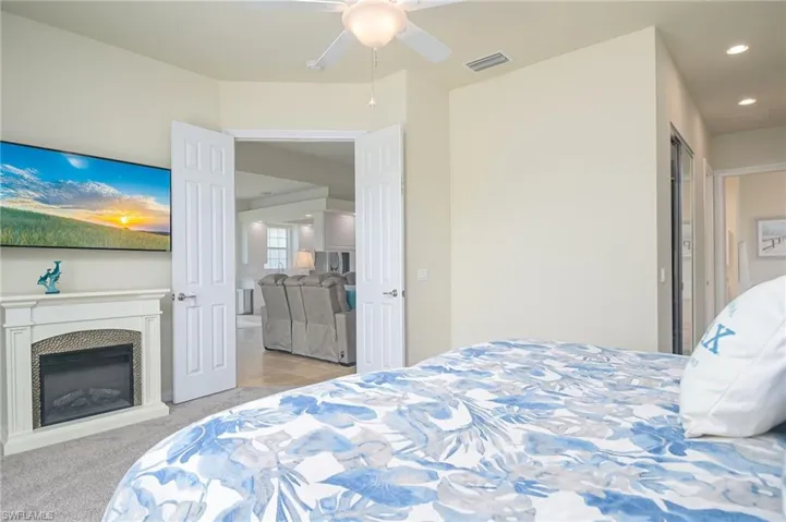 Bedroom with light carpet and ceiling fan
