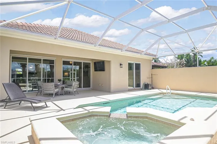 View of pool with a lanai, an in ground hot tub, and a patio area