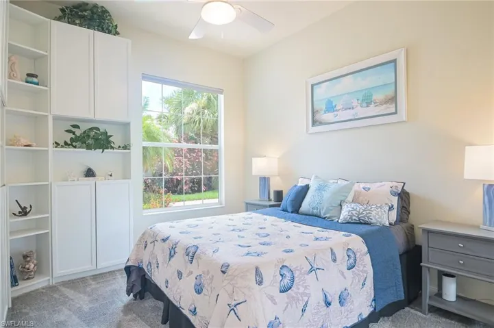 Carpeted bedroom with ceiling fan