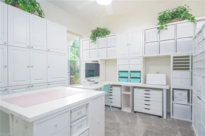Kitchen featuring light carpet, white cabinetry, plenty of natural light, and ceiling fan