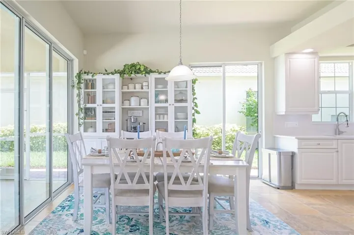 Dining room featuring sink and light tile flooring