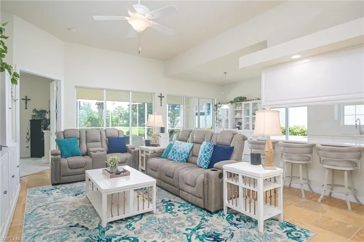 Tiled living room featuring ceiling fan