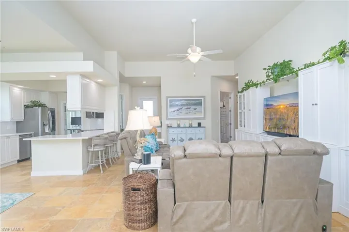 Tiled living room featuring ceiling fan