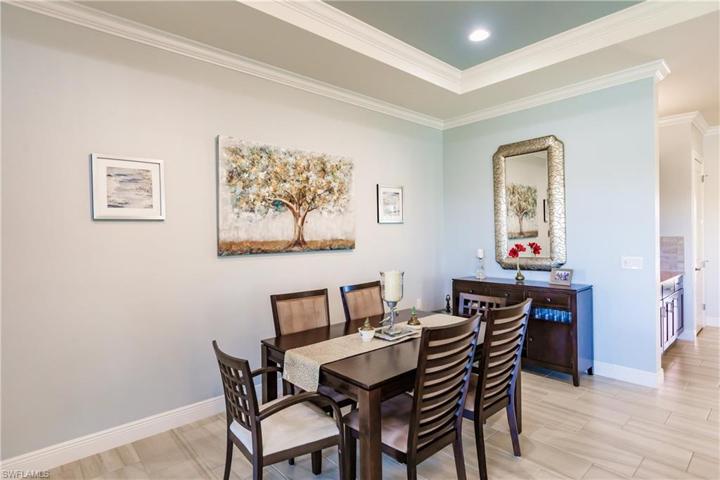 STACKED CROWN MOLDING & COFFERED CEILING MAKE THE DINING AREA SIMPLY AMAZING. THIS ELEGANT DINING ROOM TABLE & CHAIRS REMAIN WITH THE HOME FOR YOU & YOUR FAMILY TO ENJOY.