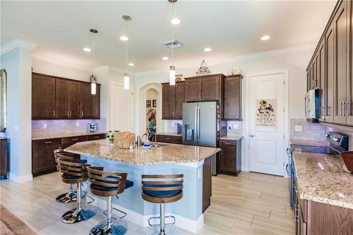 GREAT VIEW OF THE SIZE OF YOUR FUTURE KITCHEN WITH UPGRADED APPLIANCES. NOTE:THE BAR STOOLS REMAIN WITH THE HOME.