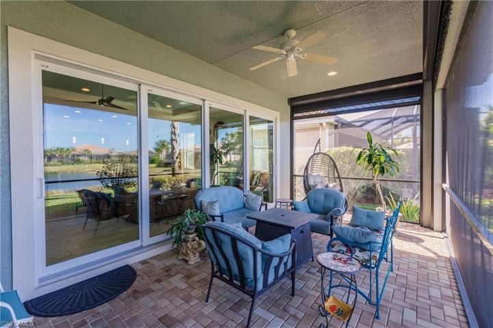 FOUR STACKABLE IMPACT RESISTANT GLASS SLIDERS IN ORDER TO ENJOY THE LAKE VIEW.  NOTE: THE ELECTRIC SUN SHADES WHICH CAN PROVIDE BOTH SHADE & PRIVACY.