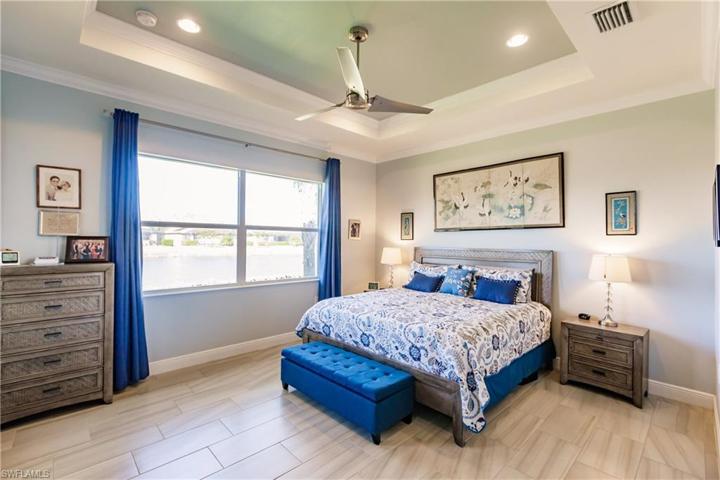 HUGE MASTER BEDROOM WITH 12X24 PLANK FLOORING, COFFERED CEILING & BEAUTIFULLY PAINTED. ENJOY THE LAKE VIEW EVERY MORNING FROM YOUR BEDROOM WINDOW.