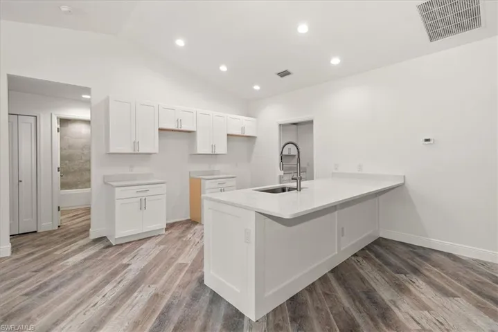 The kitchen features quartz countertops with bar seating with a large counter space. Perfect for entertaining while the chef prepares the meal.