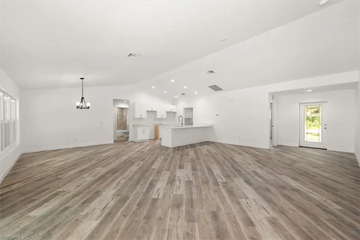 This view is from the rear sliders. Notice there is a bedroom just off the front entry that is seperate from all the other rooms. Perfect for a kids playroom or an office.