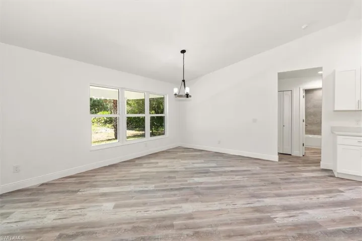 Dining view with triple windows to give a great view of the back lanai. Perfect view of a future pool area too.