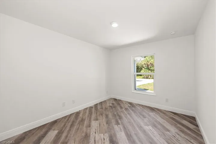 Front center guest bedroom with a front yard view.