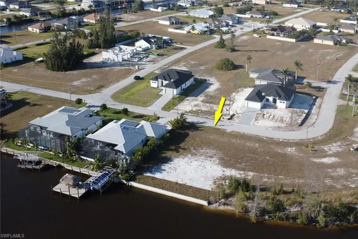 Aerial view of residential area featuring a large body of water