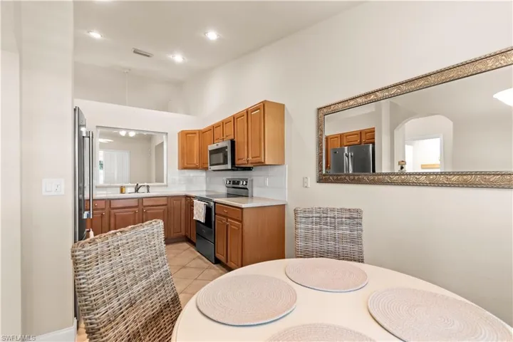Laundry area featuring separate washer and dryer, and additional cabinet space