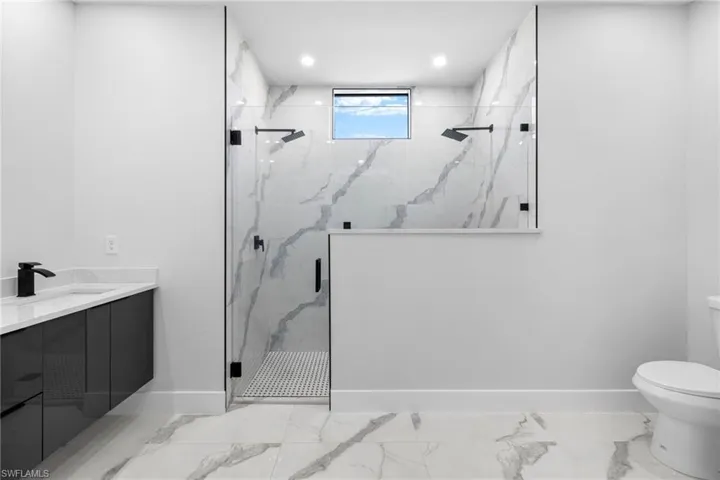 Bathroom with vanity, toilet, and walk in shower