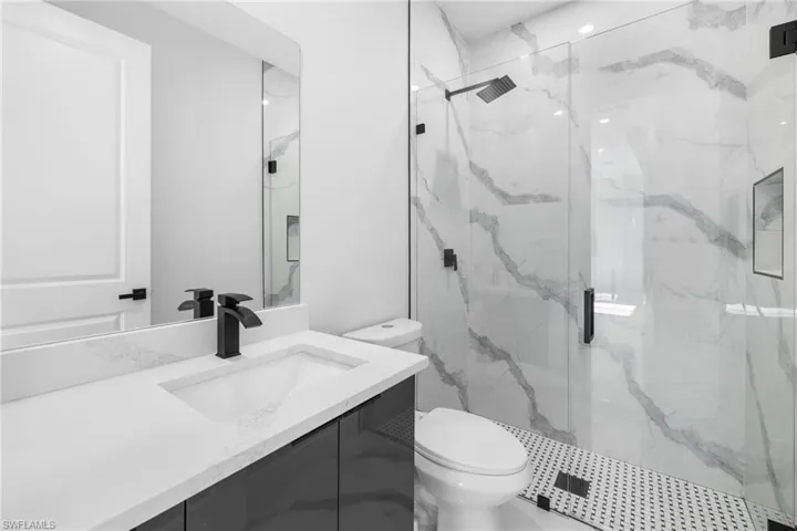 Bathroom with vanity, toilet, and walk in shower