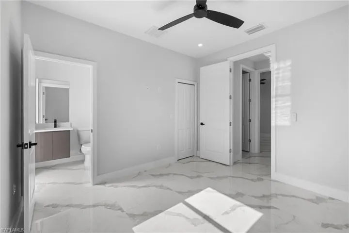 Bedroom featuring connected bathroom, a closet, and ceiling fan