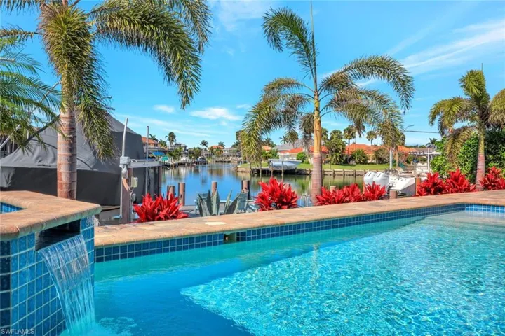 View of pool featuring pool water feature and a water view