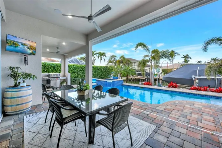 View of pool with a patio area, ceiling fan, and an in ground hot tub