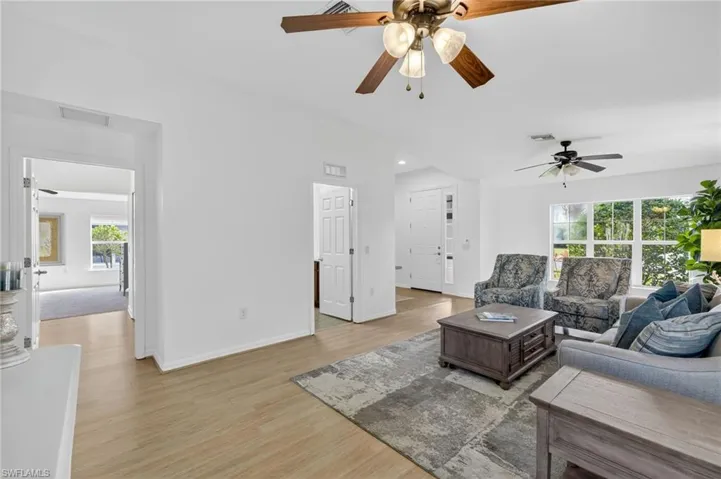 Living area featuring a ceiling fan, light wood finished floors, and recessed lighting