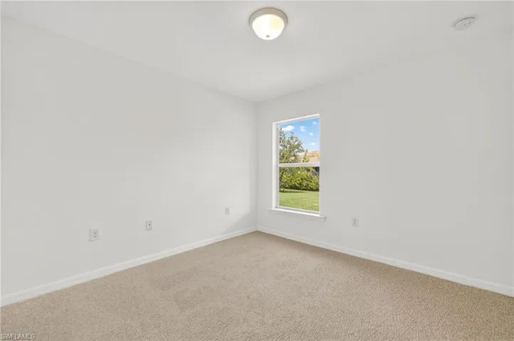 Unfurnished room featuring baseboards and light colored carpet