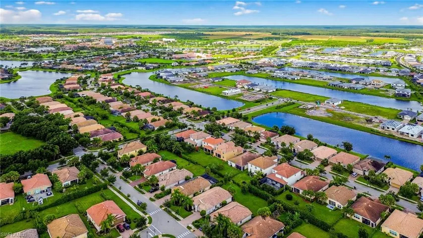 Aerial view of property and surrounding area with nearby suburban area