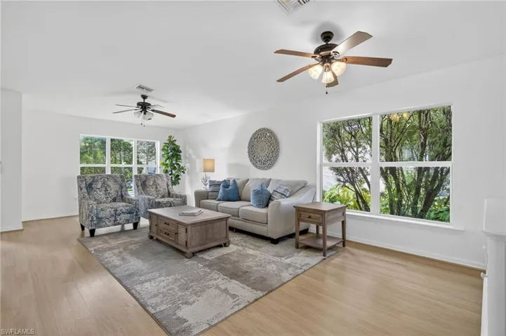 Living room featuring a ceiling fan and light wood-style flooring