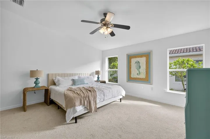 Bedroom with light carpet and ceiling fan