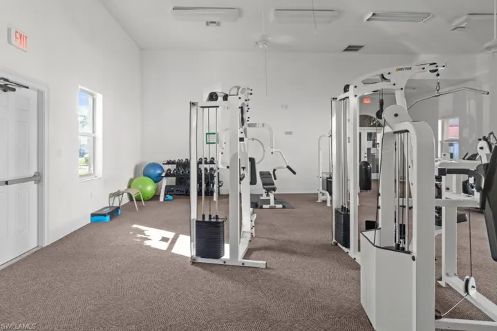 Exercise room featuring visible vents and baseboards