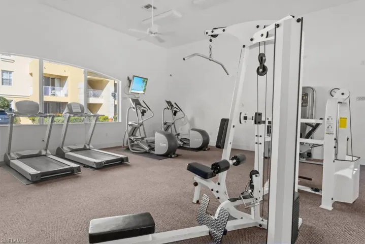 Gym with visible vents and a ceiling fan