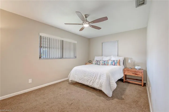Bedroom with ceiling fan and carpet floors